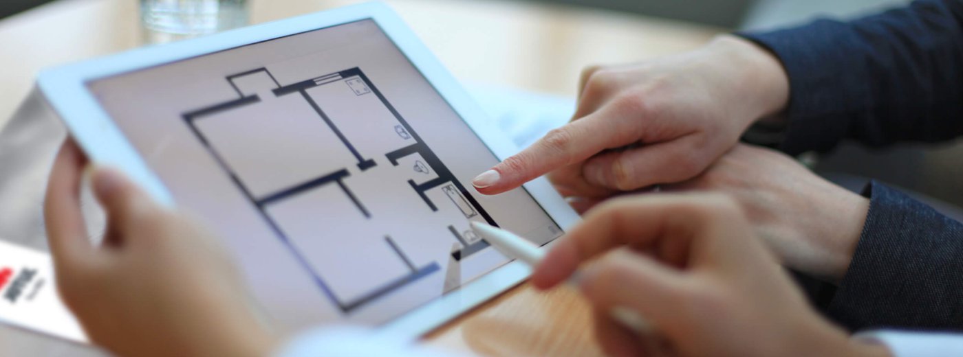 Hände zeigen auf das iPad mit dem Jøtul-Katalog